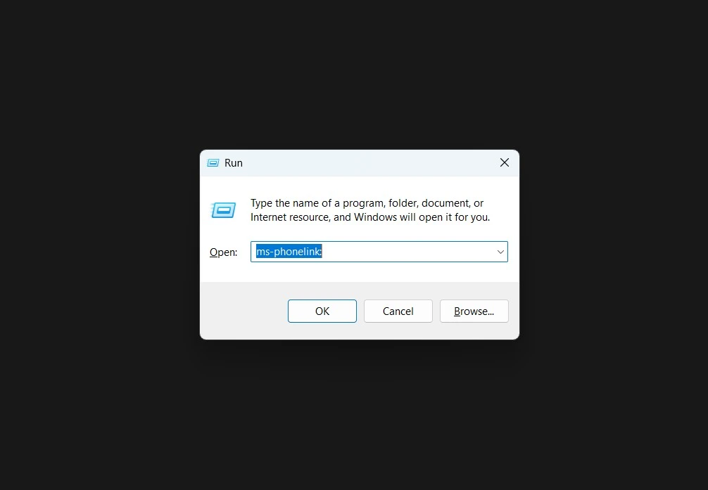 Windows Run dialog box with the 'ms-phonelink:' command entered into the text field to launch the app directly.